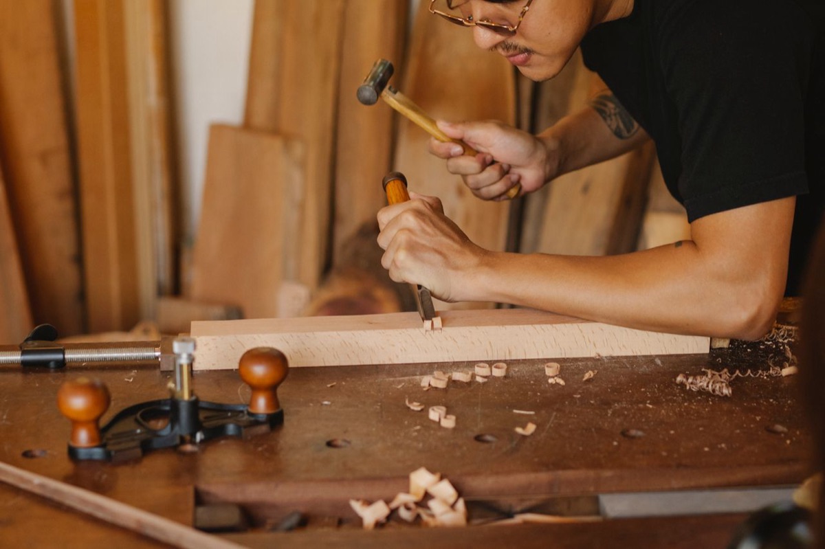 A craftsman doing careful, precise work on a piece of wood