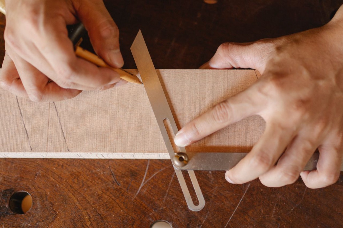 Marking a precise line on wood with a pencil and square